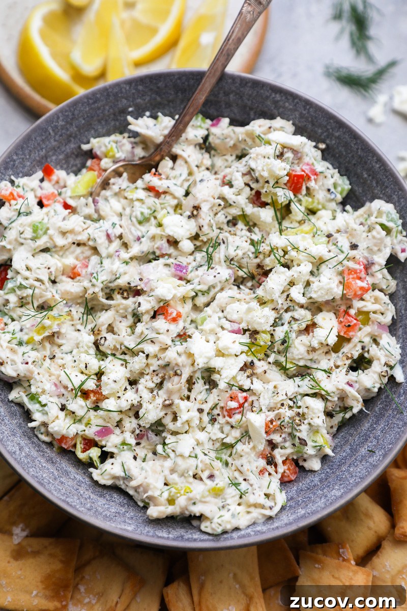 Greek-Style Feta Chicken Salad with Lemon-Dill Dressing 7 A close up photo of feta chicken salad sprinkled with fresh dill and extra feta cheese