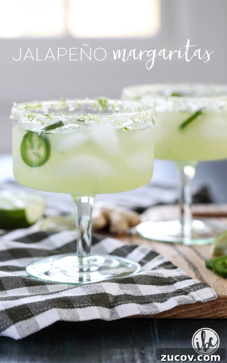 Spicy Jalapeño Margarita Recipe: How to Make It at Home 4 jalapeño margaritas in glasses on a cutting board.