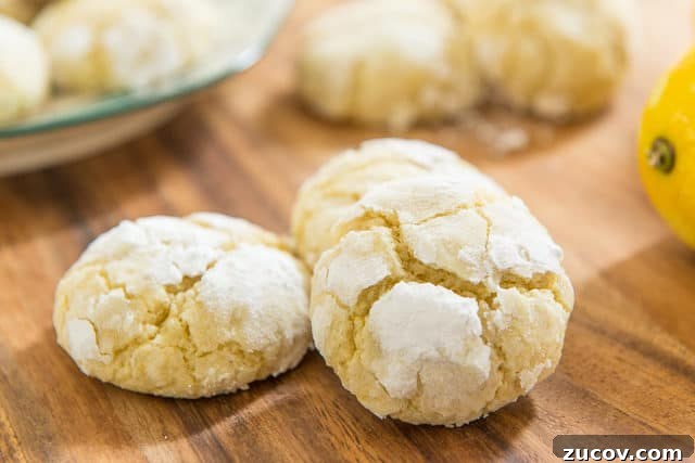 Chewy Lemon Crinkle Cookies Recipe for Bright Citrus Flavor 3 Three Lemon Christmas Cookies On A Dark Wooden Cutting Board