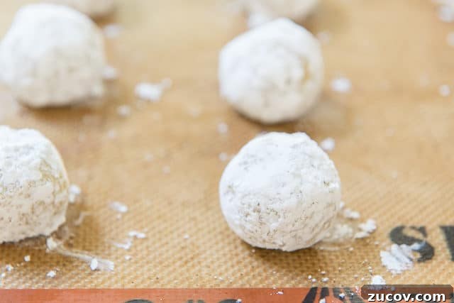Chewy Lemon Crinkle Cookies Recipe for Bright Citrus Flavor 9 Crinkle Cookie Dough Balls Rolled In Powdered Sugar On Silpat Silicone Mat