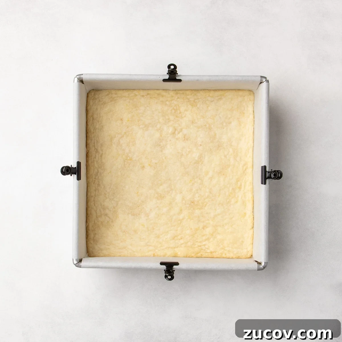 Gluten-Free Lemon Bar Recipe: Zesty, Tart Citrus Squares 11 Baked pale yellow crust in a square pan, with very lightly golden color on the edges.