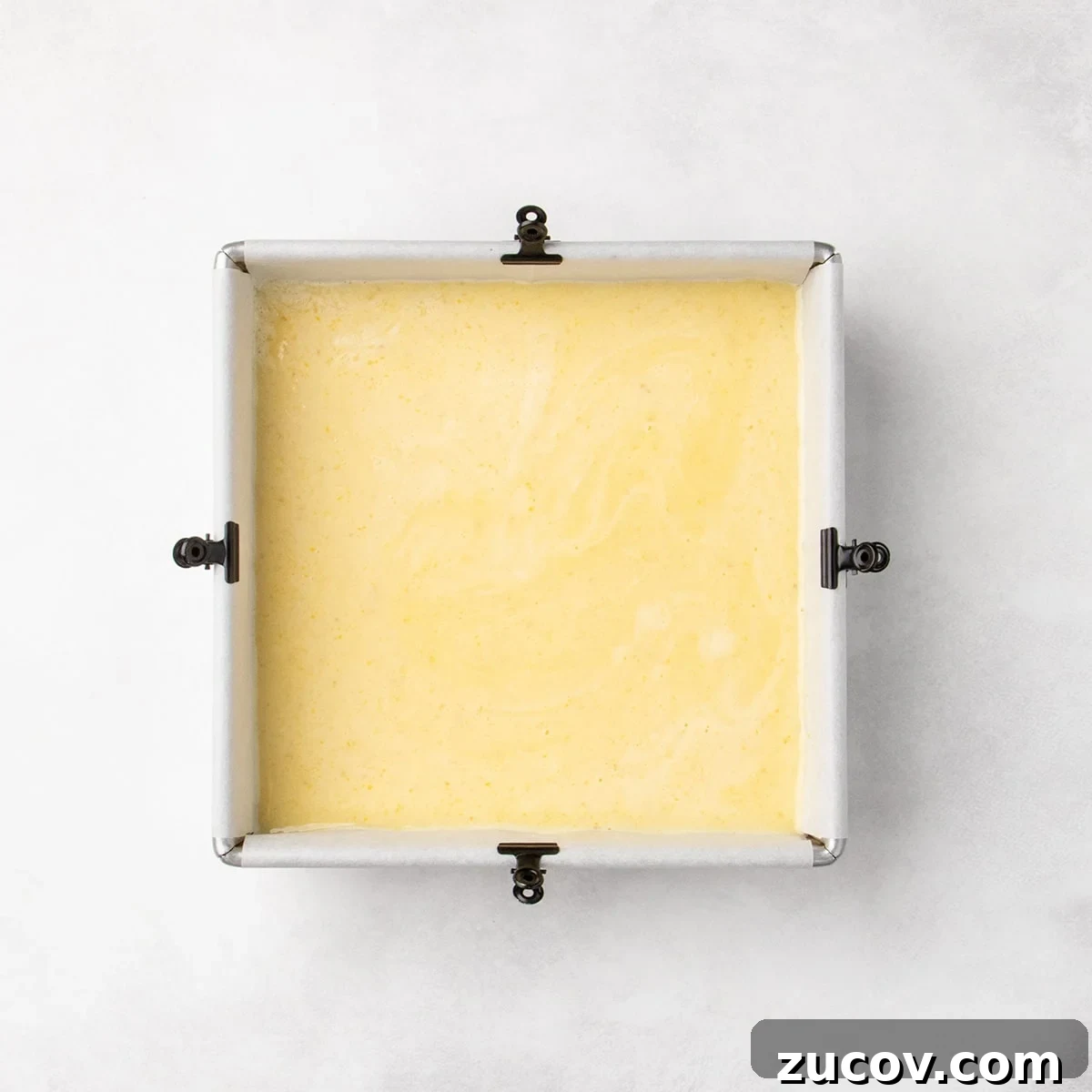 Gluten-Free Lemon Bar Recipe: Zesty, Tart Citrus Squares 15 Square pan filled with a smooth pale yellow layer over the crust, spread evenly to the edges.