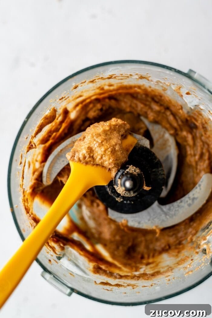No-Bake Chocolate Caramel Tart Recipe for Quick Desserts 8 Blended, creamy caramel in a food processor with a spatula.