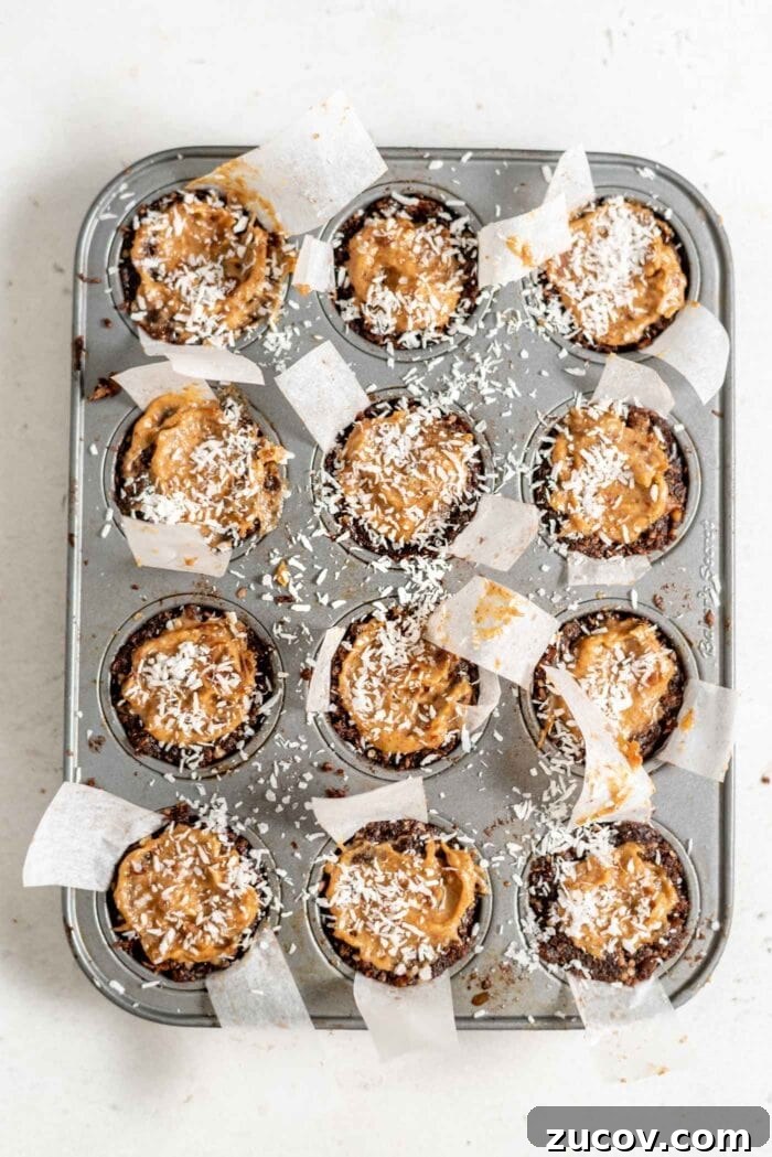 No-Bake Chocolate Caramel Tart Recipe for Quick Desserts 9 Caramel tarts topped with coconut in a muffin tin.