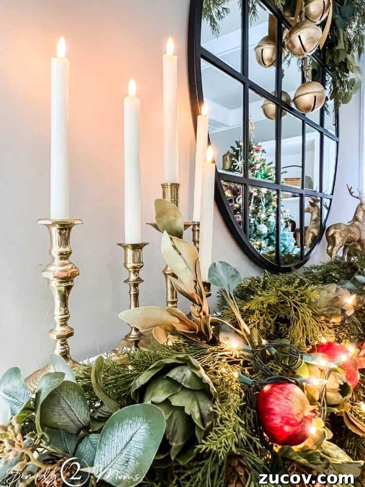 13 Elegant Christmas Fireplace Decorating Ideas to Try This Year 8 Five brass candlesticks with faux candles on a mantle decorated for Christmas.