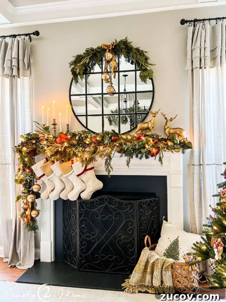 13 Elegant Christmas Fireplace Decorating Ideas to Try This Year 9 Gas fireplace with asymmetrical Christmas garland, stockings, round mirror with greenery, and gold reindeer.