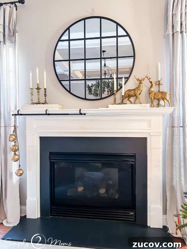 13 Elegant Christmas Fireplace Decorating Ideas to Try This Year 3 Gas fireplace with traditional trim mantel. A stocking rod is attached and wood is stacked on top to raise decorations above Xmas greenery.