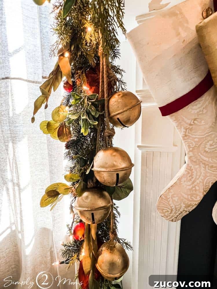 13 Elegant Christmas Fireplace Decorating Ideas to Try This Year 5 Four extra large jingle bells strung on jute rope and hanging in Christmas garland from a fireplace.
