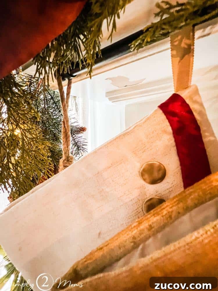 13 Elegant Christmas Fireplace Decorating Ideas to Try This Year 6 Close up of stocking loop hanging on a stocking rod attached to a fireplace mantel.