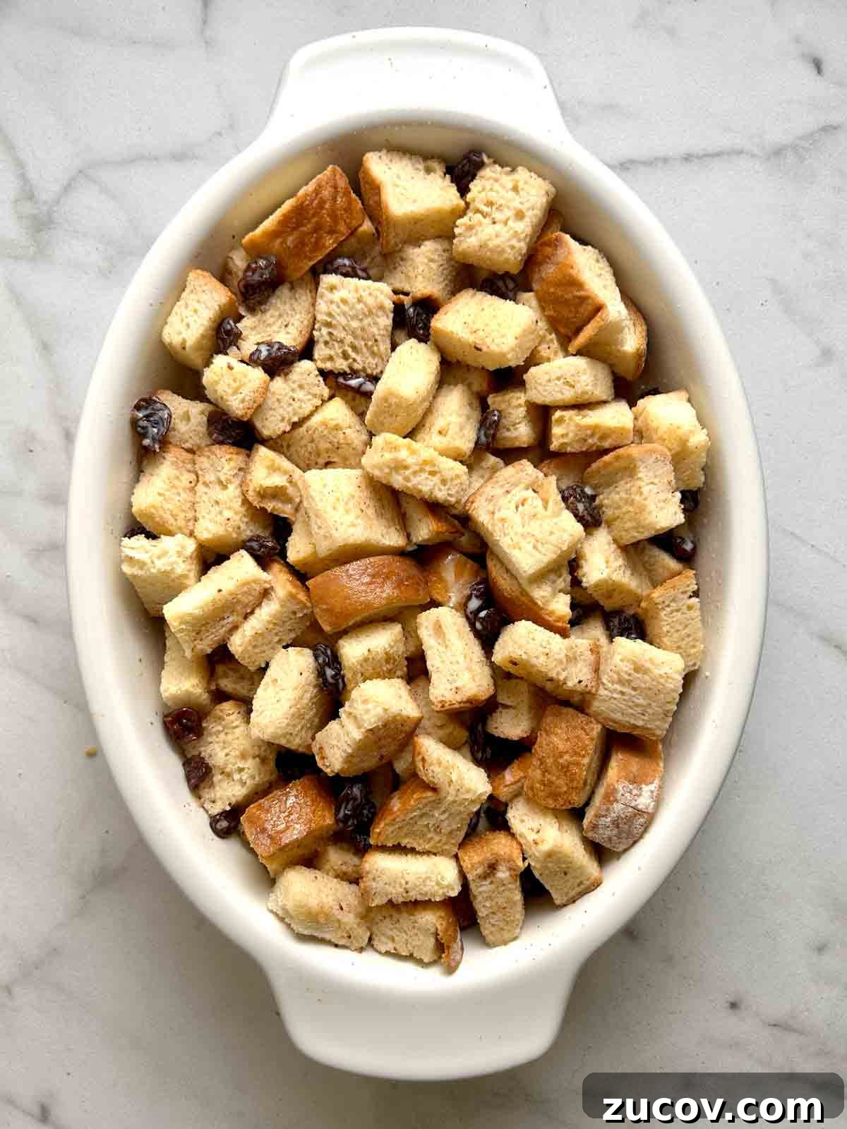 Classic Bread Pudding Recipe with Caramel Sauce and Vanilla 5 custard poured over bread cubes.