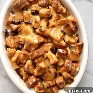 Classic Bread Pudding Recipe with Caramel Sauce and Vanilla 8 bread pudding with vanilla sauce drizzled over it.