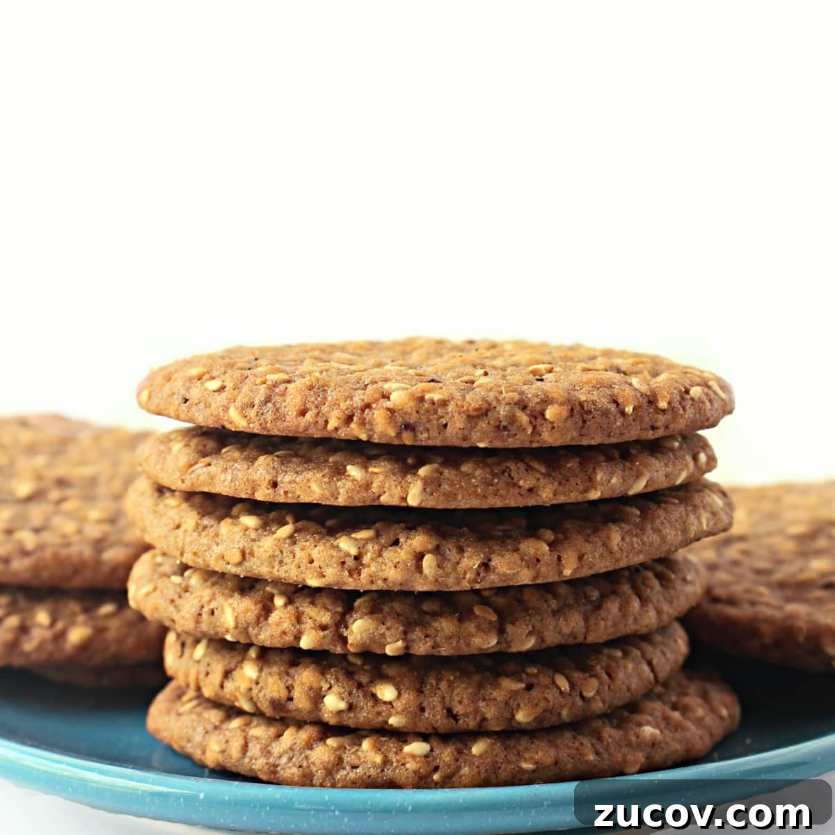 Sesame Benne Wafers: Crispy South Carolina Cookie Recipe 5 Stack of thin sesame cookies on a blue plate.
