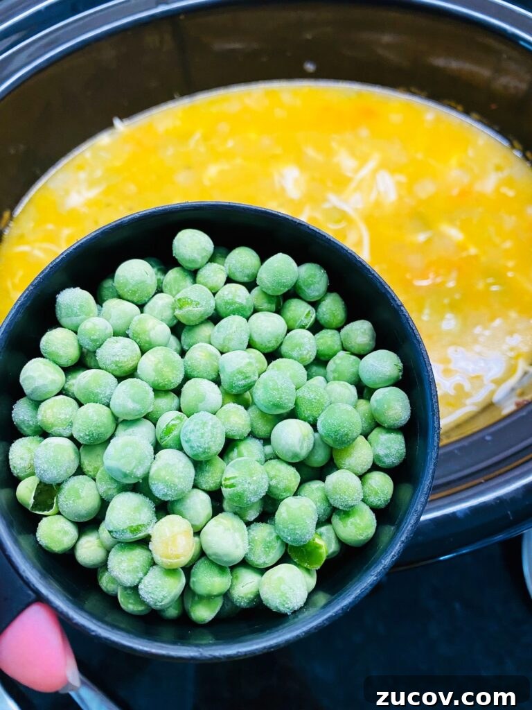 Slow Cooker Chicken with Fluffy Dumplings Recipe 6 adding peas to crock pot