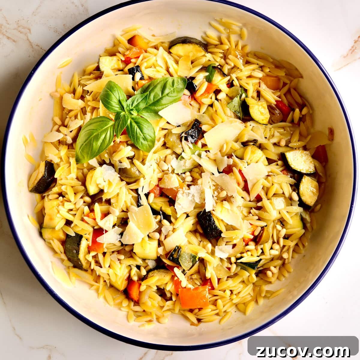 Orzo vs Risotto: Key Differences, Cooking Tips & Recipes 4 Orzo pasta with roasted vegetables and parmesan in a bowl.