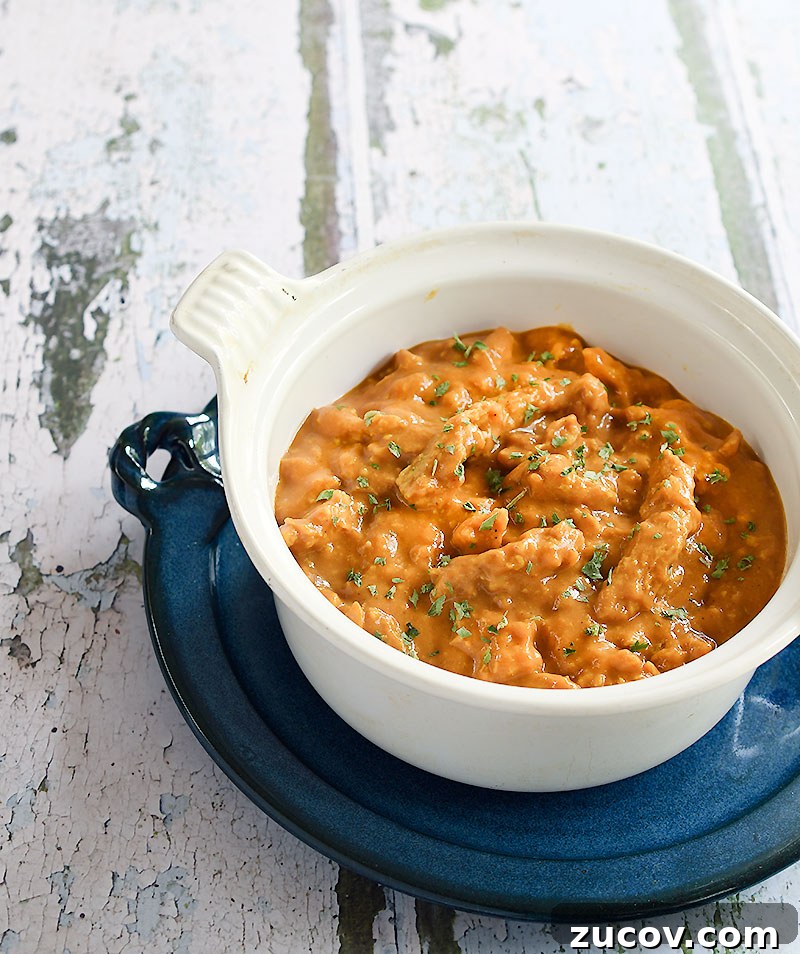 Oil-Free Vegan Butter Chicken with Soy Curls: Creamy Plant-Based Recipe 5 vegan butter chicken made with soy curls in a white Le Cresuet pot on a blue ceramic plate