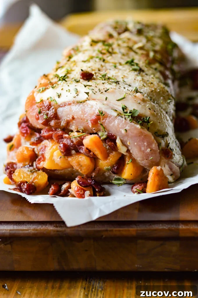 Fruit-Stuffed Pork Loin Roast with Apple and Cranberry Filling 6 Fruit Stuffed Pork Loin Roast with Peach Glaze - stuffed on parchment paper