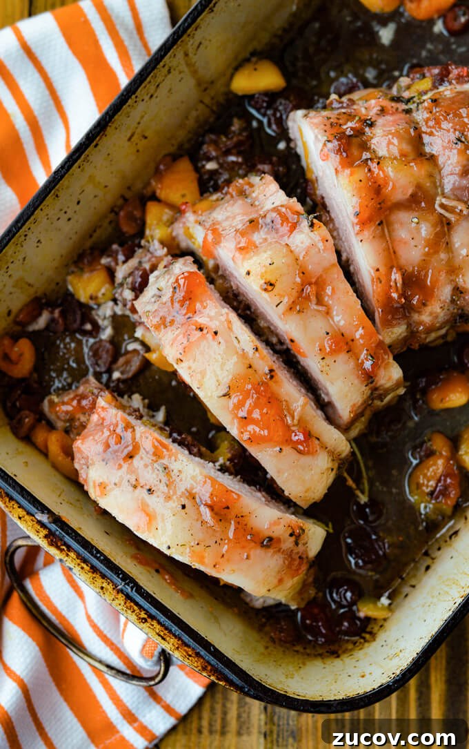 Fruit-Stuffed Pork Loin Roast with Apple and Cranberry Filling 8 Fruit Stuffed Pork Loin Roast with Peach Glaze - cooked in a pan