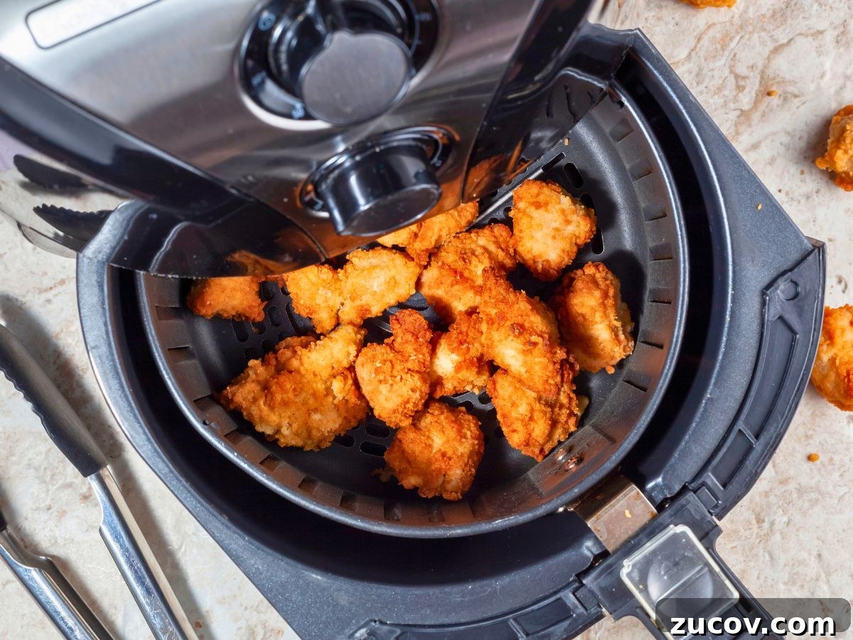 How to Reheat Chicken Tenders: 4 Quick Methods for Crispy Results 4 Chicken strips in an air fryer.