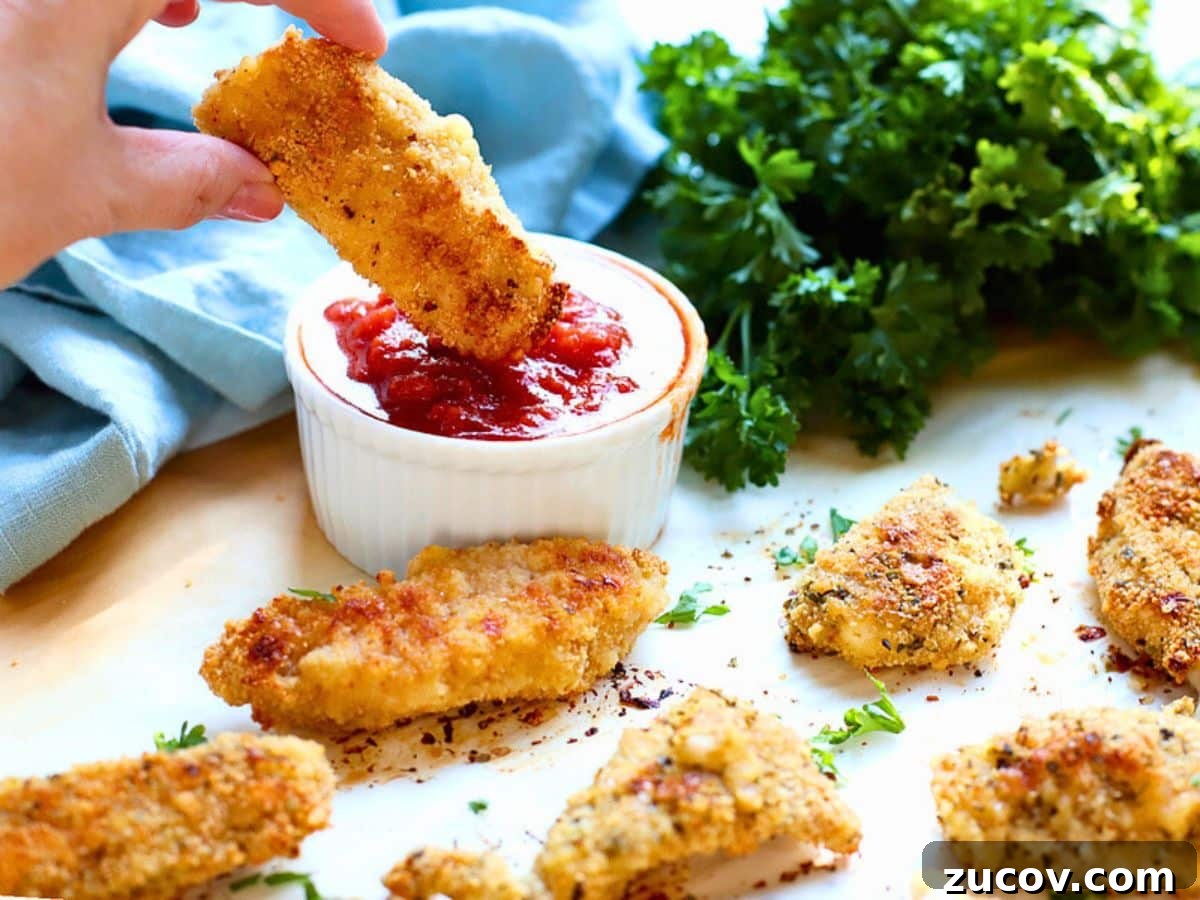 How to Reheat Chicken Tenders: 4 Quick Methods for Crispy Results 5 Chicken tender being dipped into sauce.