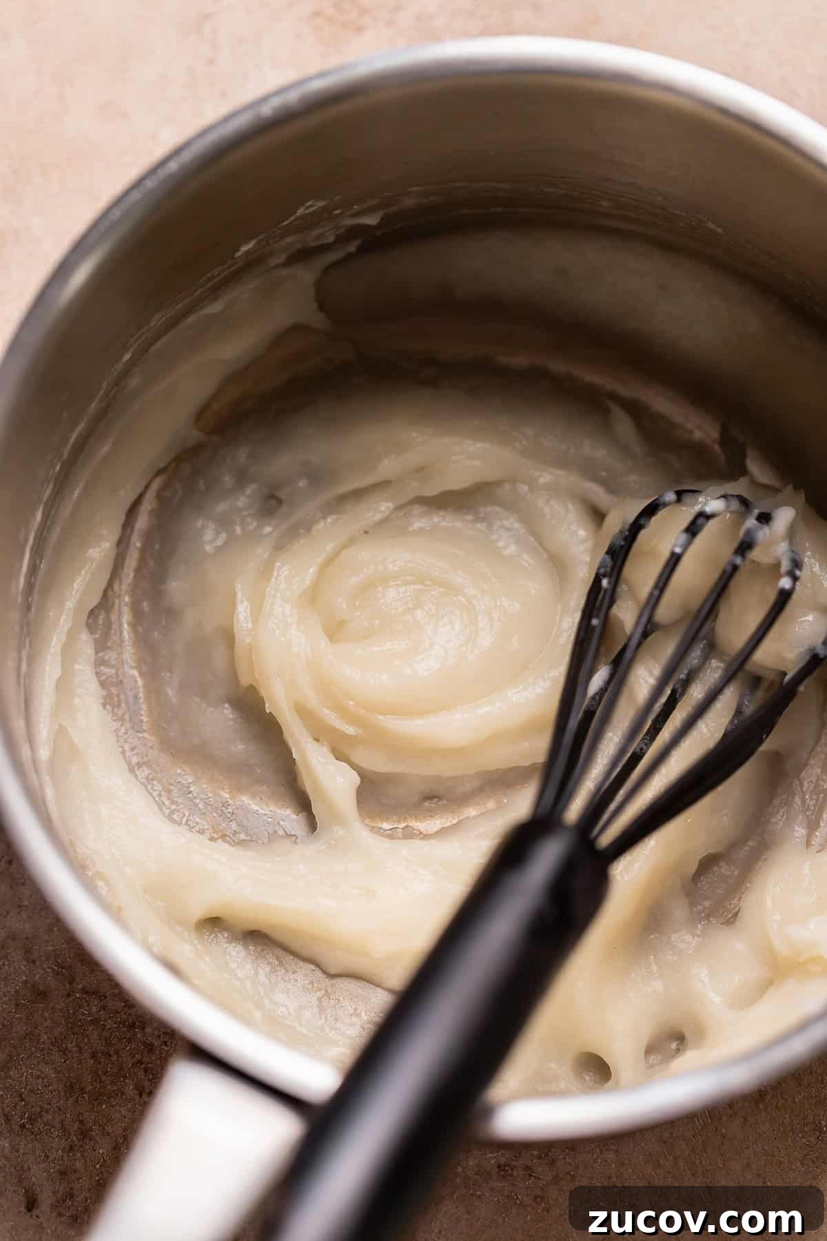 Tangzhong being whisked into a paste in a pot.