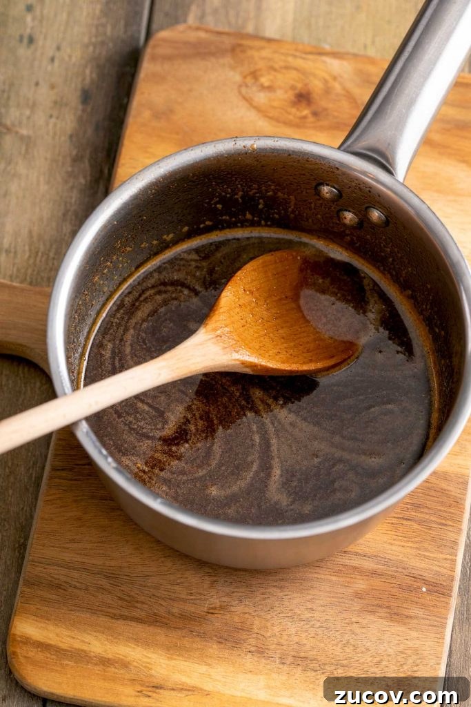 Homemade Honey Baked Ham Recipe (Copycat) 9 sugar mixture with the ham drippings combined in a saucepan.