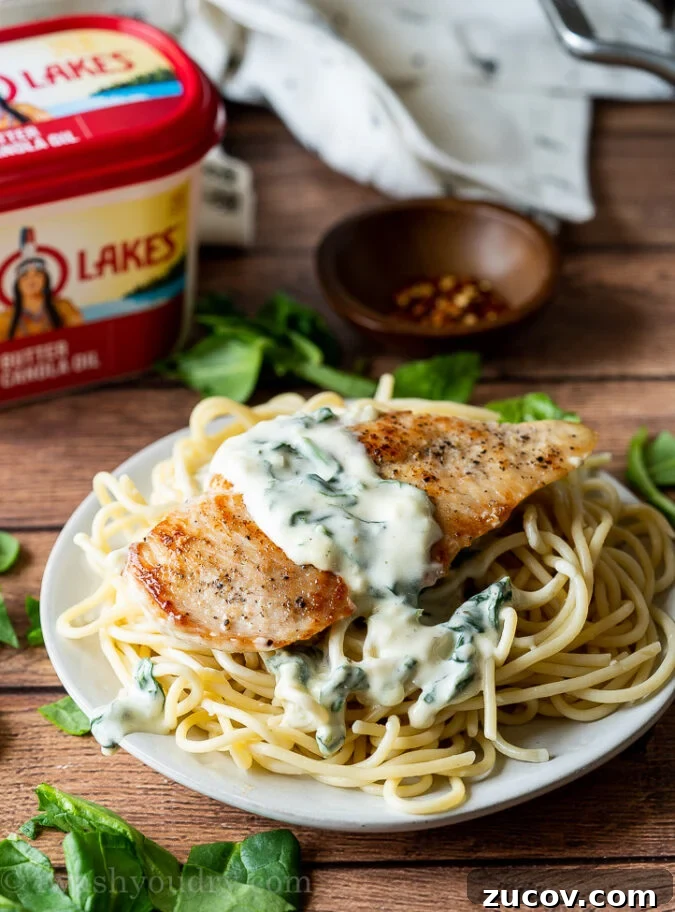 Creamy Garlic Chicken Dinner with Parmesan and Herbs 5 Family enjoying creamy garlic parmesan chicken with wilted spinach.