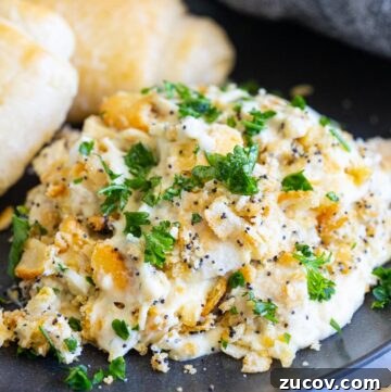 poppy seed chicken with bread rolls on a plate