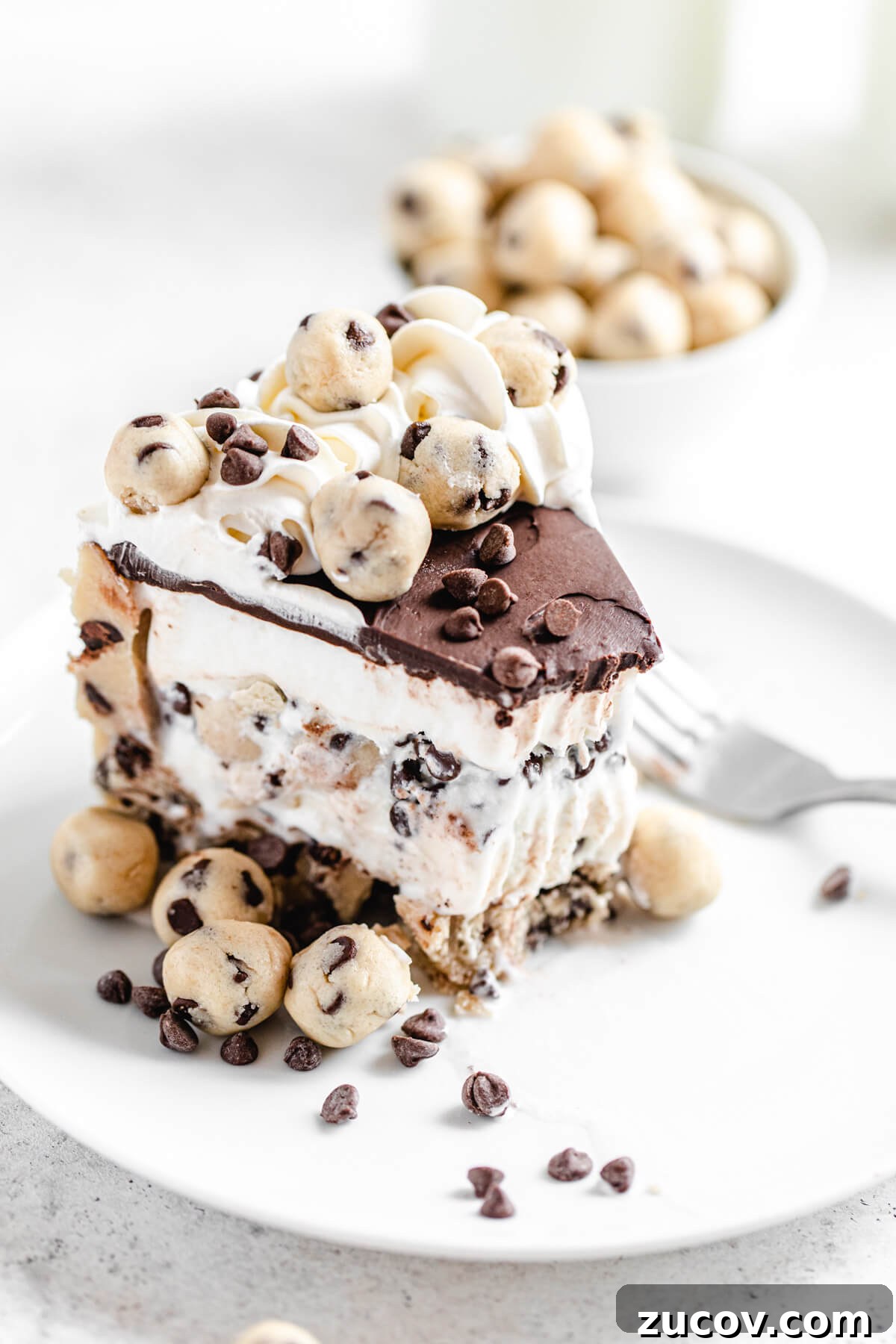 Chocolate Chip Cookie Dough Ice Cream Cake Recipe for Summer Parties 10 half eaten slice of ice cream cake on a white plate