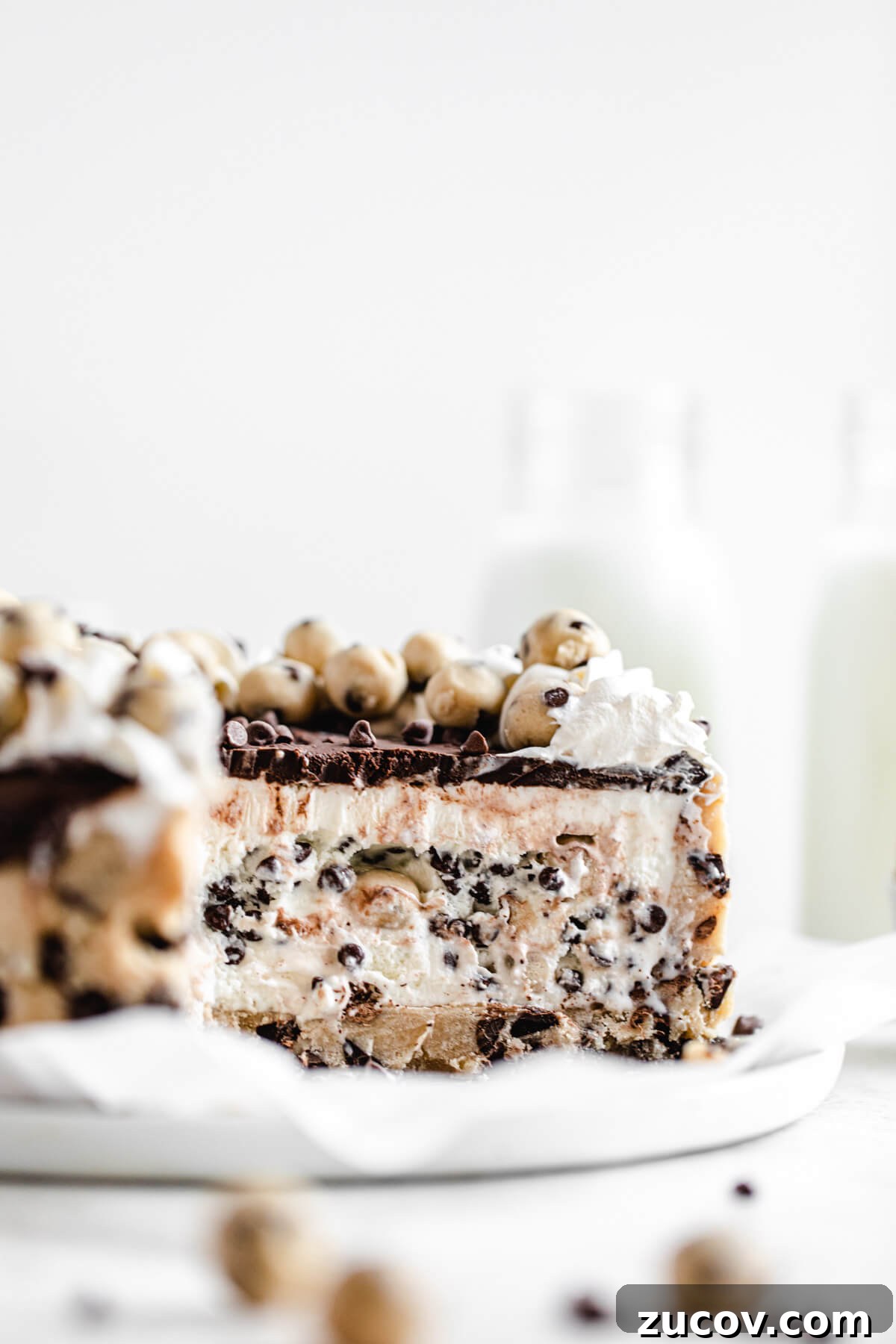 Chocolate Chip Cookie Dough Ice Cream Cake Recipe for Summer Parties 11 sliced ice cream cake on a parchment covered white plate