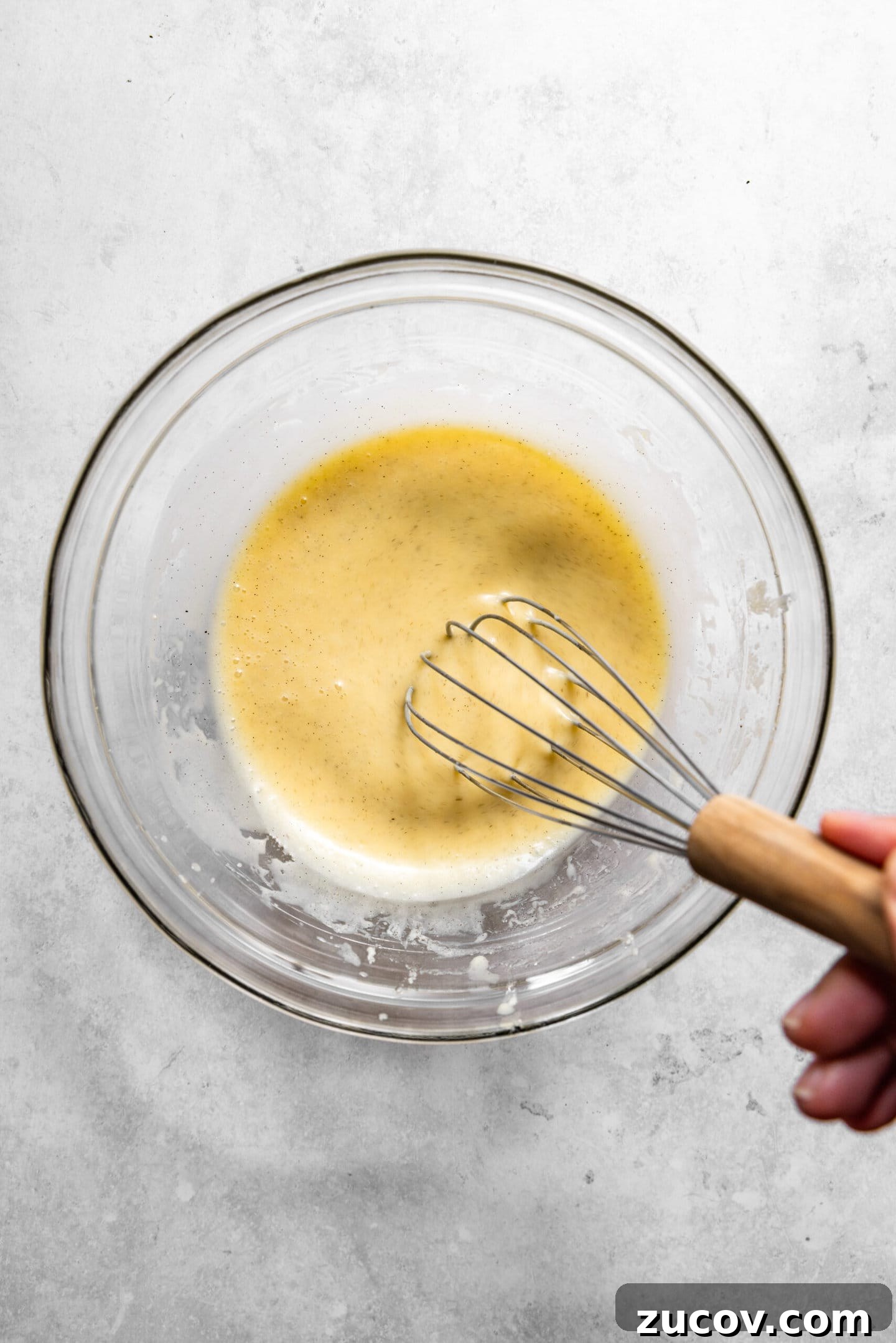 Small-Batch Chocolate Chip Muffins Made with Sour Cream 6 Wet ingredients being whisked together