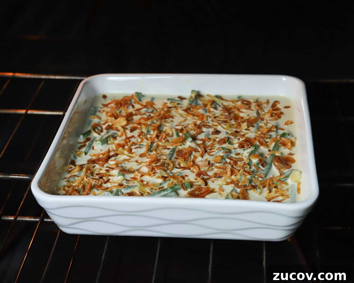 Vegan Green Bean Casserole Recipe with Crispy Onion Topping 8 Photo of green bean casserole baking in the oven.