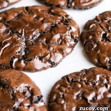 Chewy Flourless Chocolate Chip Cookies You’ll Love 6 double chocolate chip cookies on parchment paper