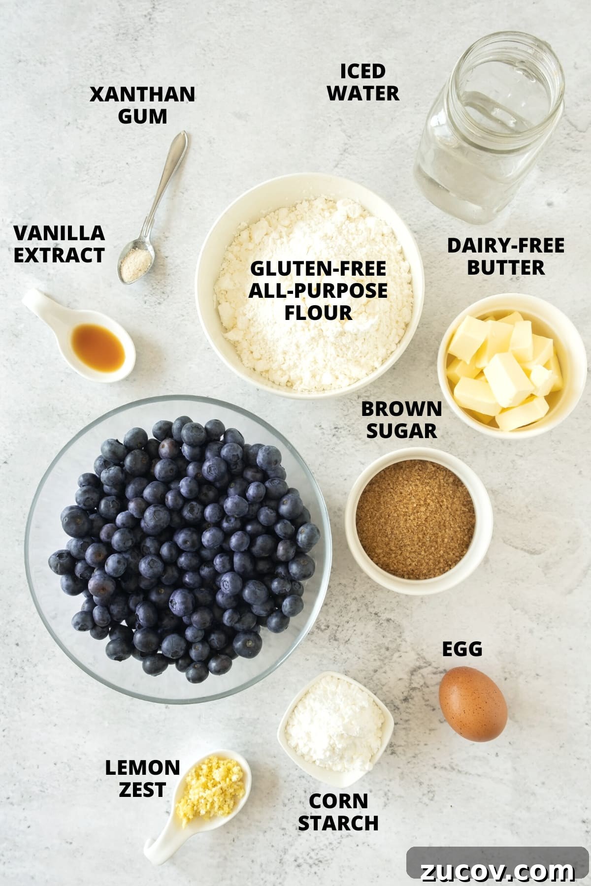 Gluten-Free Blueberry Pie Recipe (Dairy-Free) Ingredients for blueberry pie recipe laid out on a white board.