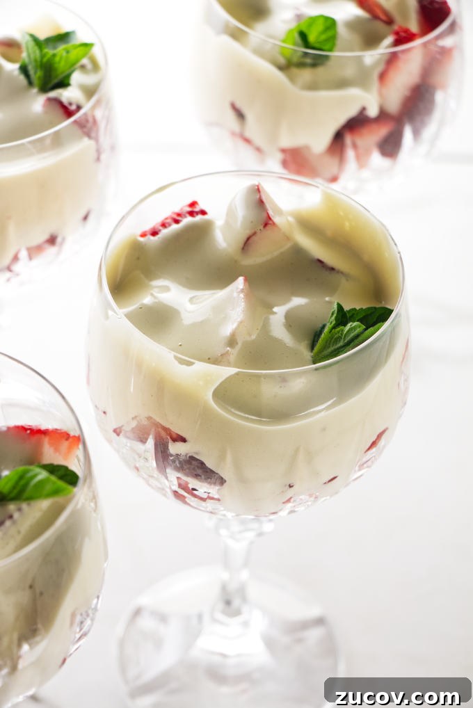 Strawberry Zabaglione Recipe: Light Italian Dessert with Creamy Custard 5 Four wine glasses filled with zabaglione and strawberries.