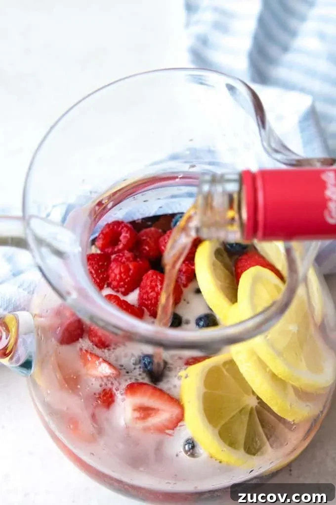 Berry Rosé Sangria Recipe for Summer Parties 4 rosé being poured into a pitcher