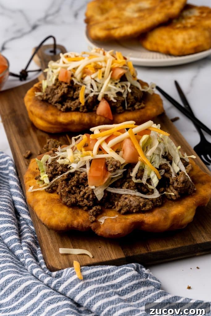 Navajo Tacos: Authentic Indian Fry Bread Recipe & Tips 11 navajo tacos on indian fry bread on a wooden cutting board
