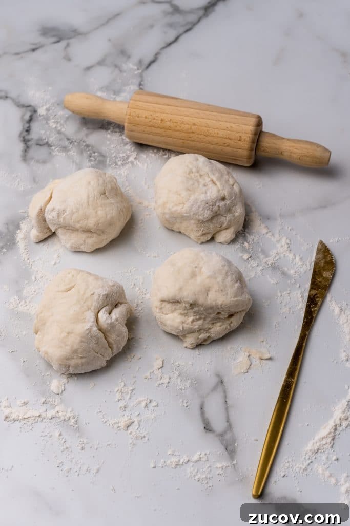 Navajo Tacos: Authentic Indian Fry Bread Recipe & Tips 8 four balls of dough on a floured counter top