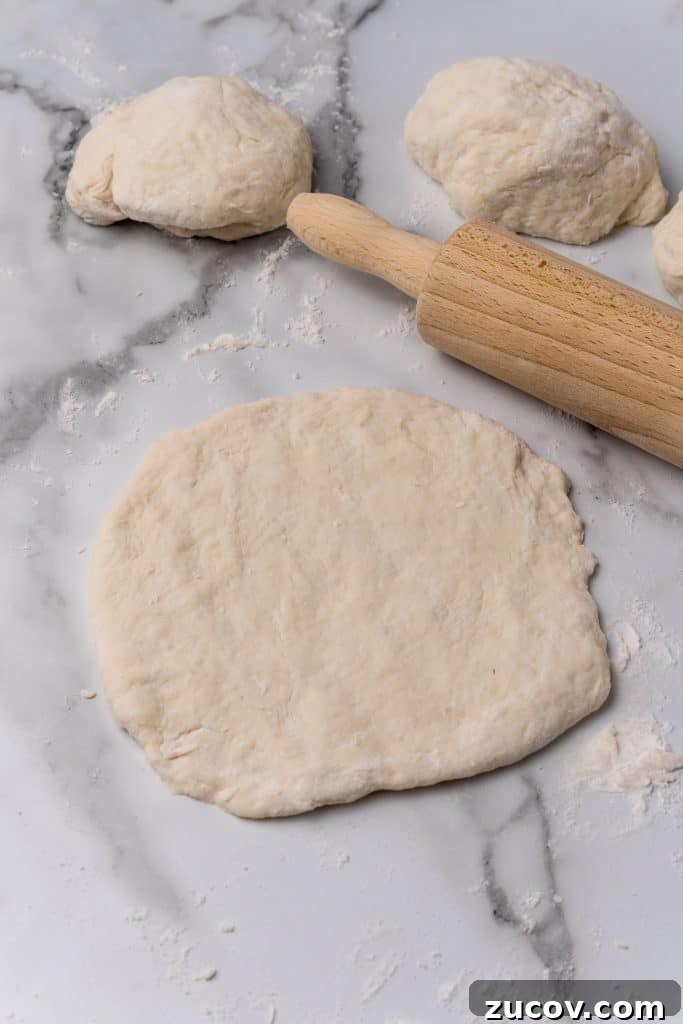 Navajo Tacos: Authentic Indian Fry Bread Recipe & Tips 9 rolled out dough for cherokee fry bread on a floured counter