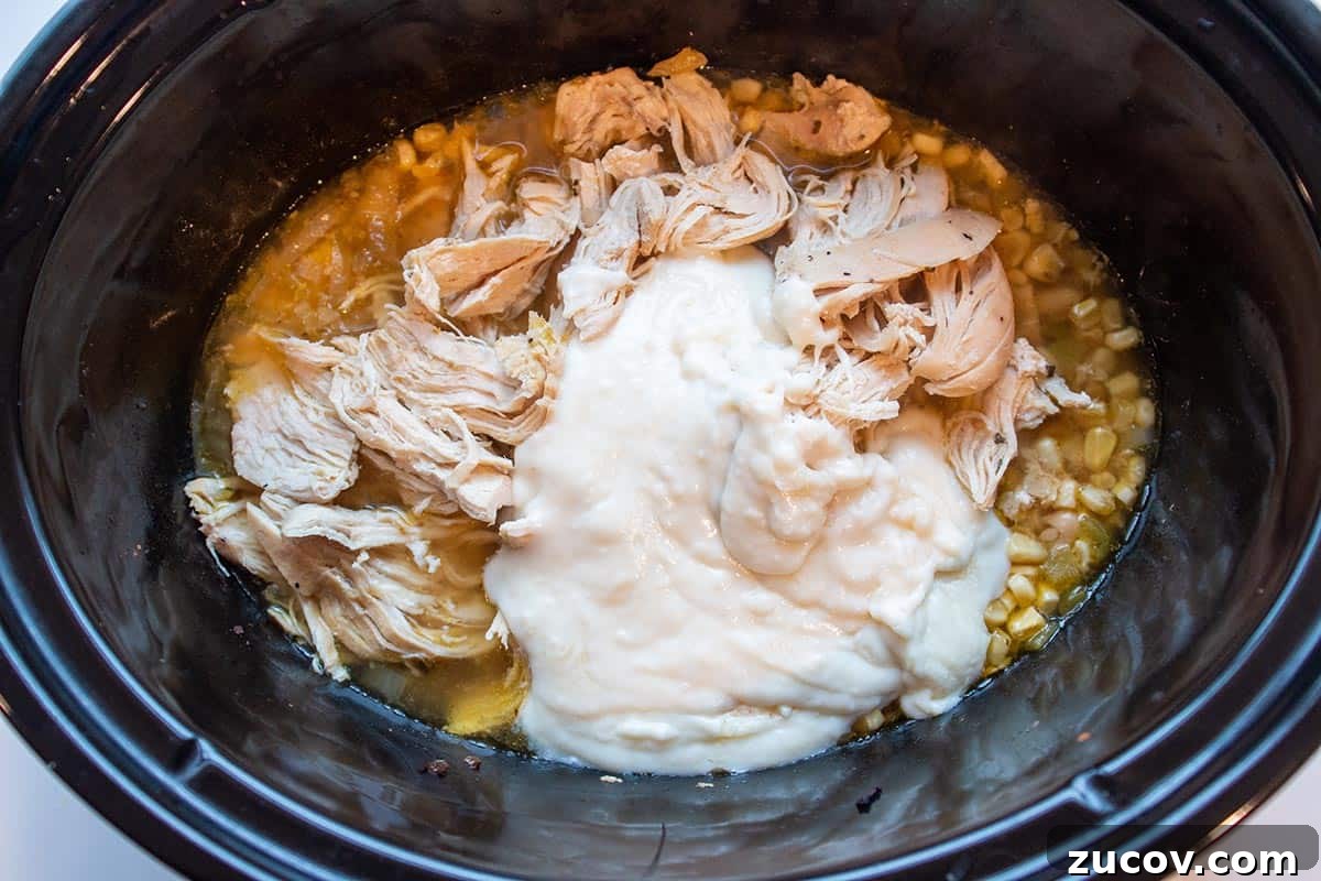 Slow-Cooker Creamy White Chicken Chili Recipe 11 Crock-Pot with shredded chicken, corn, white beans and a homemade roux.