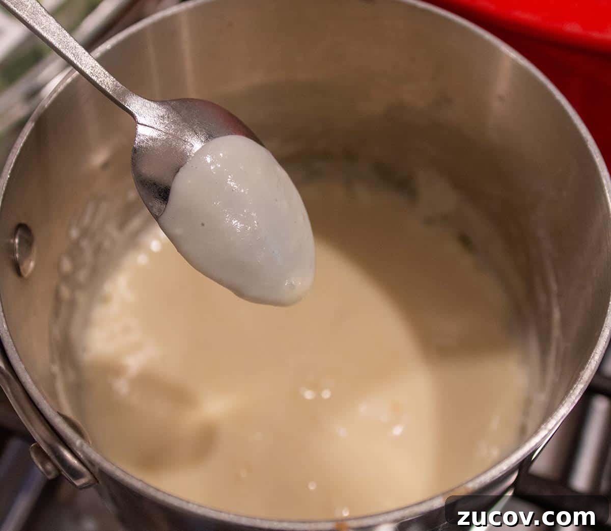 Slow-Cooker Creamy White Chicken Chili Recipe 10 A spoon with a coating of homemade roux.