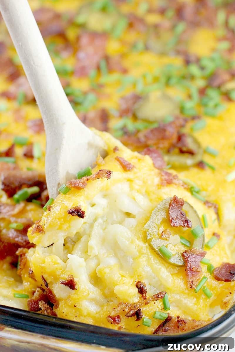 Jalapeño Popper Hash Brown Casserole Recipe for Spicy Comfort 6 wooden spoon lifting up jalapeno breakfast casserole