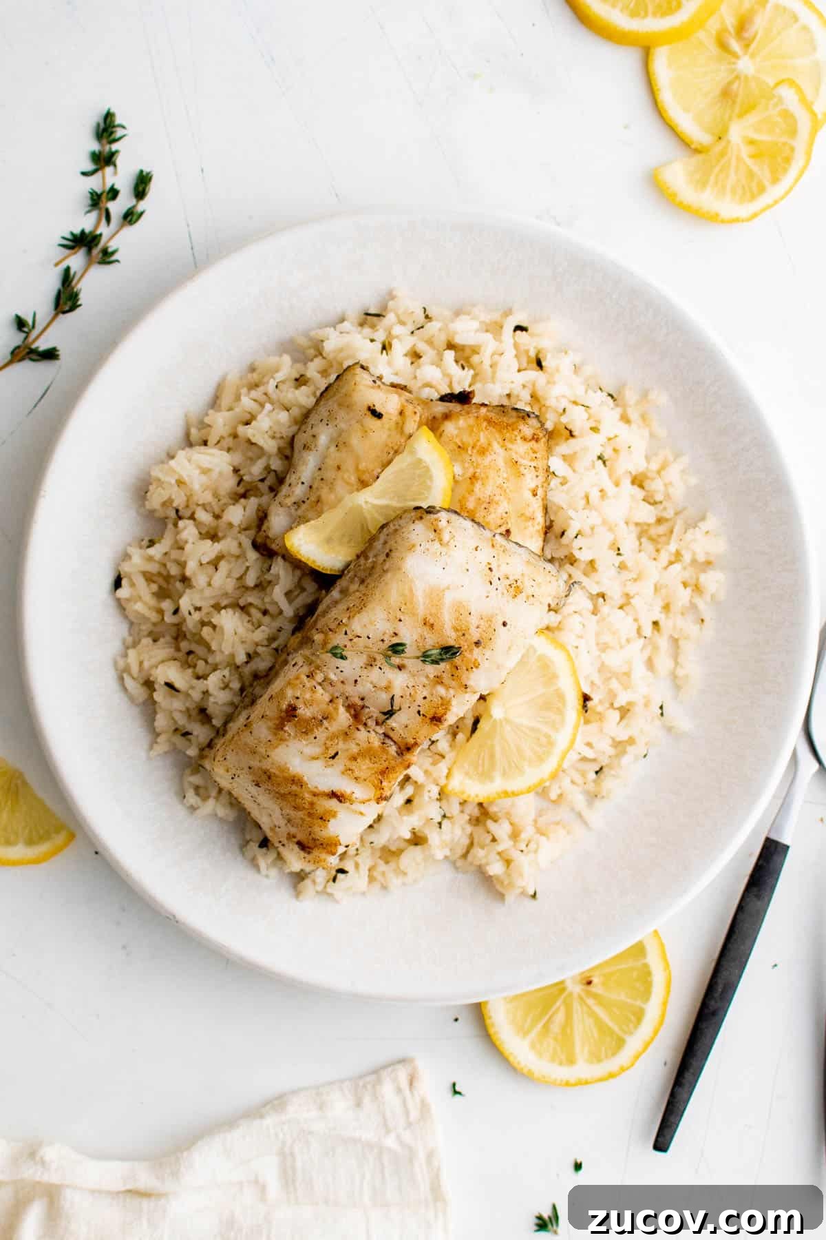 Pan-Seared Chilean Sea Bass with Garlic Herb Rice Recipe 6 a plate with garlic and herb rice and chilean sea bass