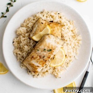 Pan-Seared Chilean Sea Bass with Garlic Herb Rice Recipe 7 a plate with garlic and herb rice and chilean sea bass