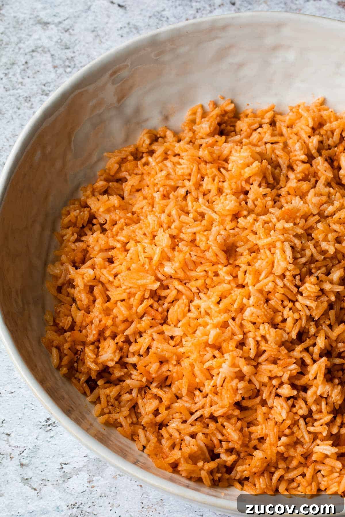 Instant Pot Arroz Rojo (Mexican Red Rice) 11 close up of mexican rice in a white bowl