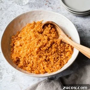 Instant Pot Arroz Rojo (Mexican Red Rice) 12 bowl of mexican rice with a wooden spoon