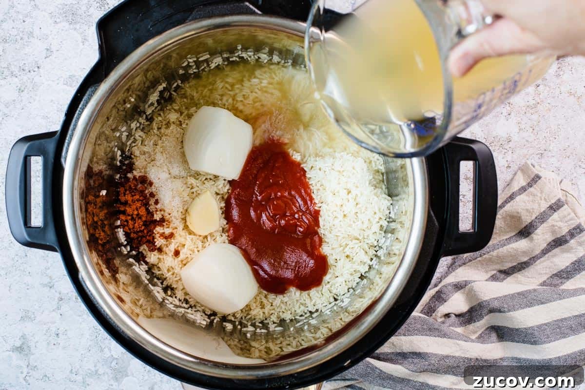 Instant Pot Arroz Rojo (Mexican Red Rice) 7 adding broth to instant pot