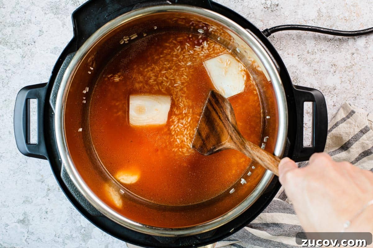 Instant Pot Arroz Rojo (Mexican Red Rice) 8 stirring rice mixuture