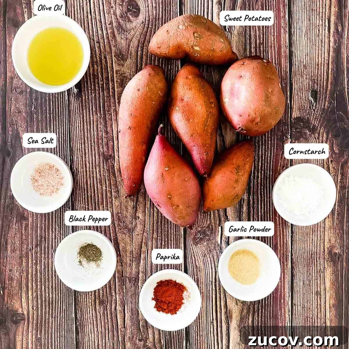 Crispy Air-Fryer Sweet Potato Fries Coated in Cornstarch 3 The ingredients to make air fryer sweet potato fries on a wooden table.