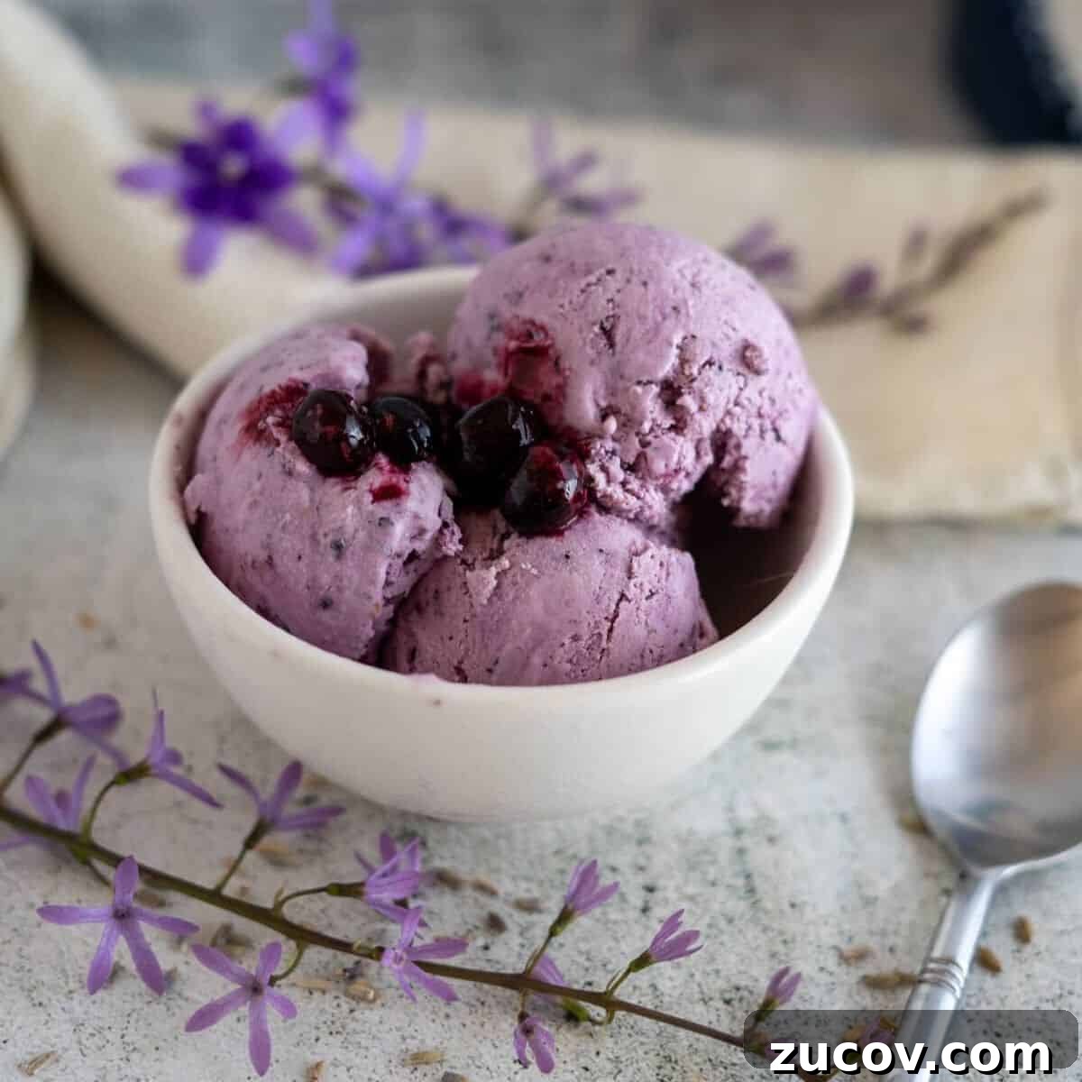 Keto Peach Ice Cream Recipe: Creamy Low-Carb Frozen Dessert 9 lavender ice cream in bowl with berries