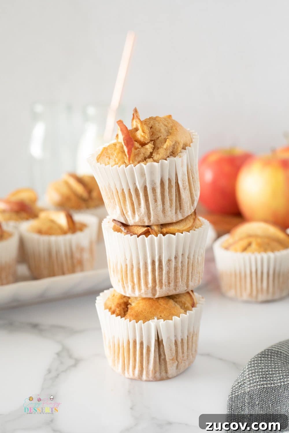 Warm Apple Cinnamon Muffins with Crumble Topping 5 A stack of apple and cinnamon muffins